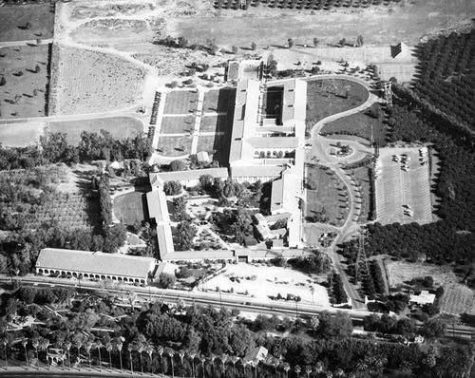 Aerial view of large building complex, landscape.